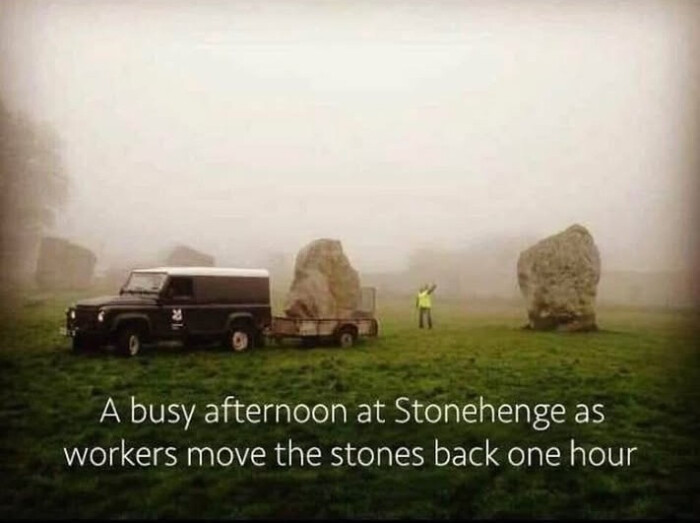 A busy afternoon at Stonehenge as workers move the stones back one hour